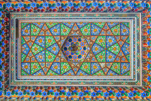 A beautiful wooden ceiling carved in oriental style and painted with Asian designs in a museum in Tashkent