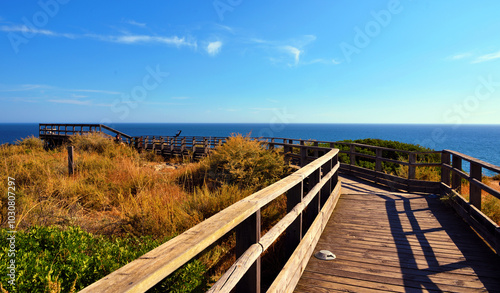 wooden walkway on algar seco amidst beautiful rock formations in Carvoeiro, Lagoa, Algarve, Portugal photo