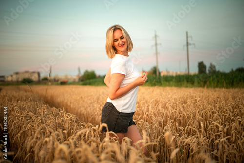 Portrait of a young beautiful blonde girl in a wheat field.