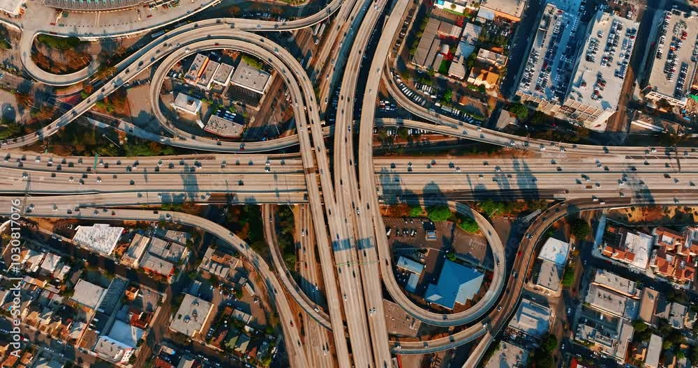 Highways, freeways and loops are busy with moving cars. Top view on the interchange in Los Angeles, California, USA. Highways, freeways and loops are busy with moving cars. Top view on the interchange in Los Angeles, California, USA.