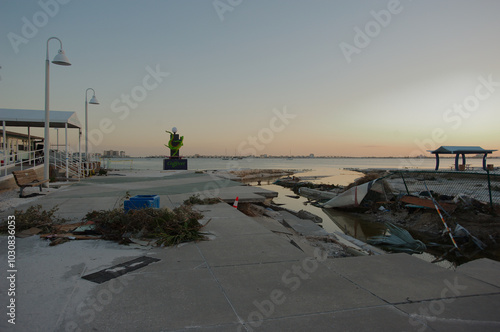 Beach damaged storm surge  after hurricanes Helene and Milton at Gulfport Beach in Florida. Ruts, gulleys,  water channels and debris in sand Late afternoon Sun with room for copy. Blue Skies and bay  photo