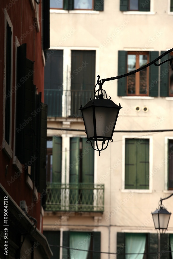 Decorative lantern on the street, in the background of an old building in Italy Decorative lantern on the street, in the background of an old building in Italy