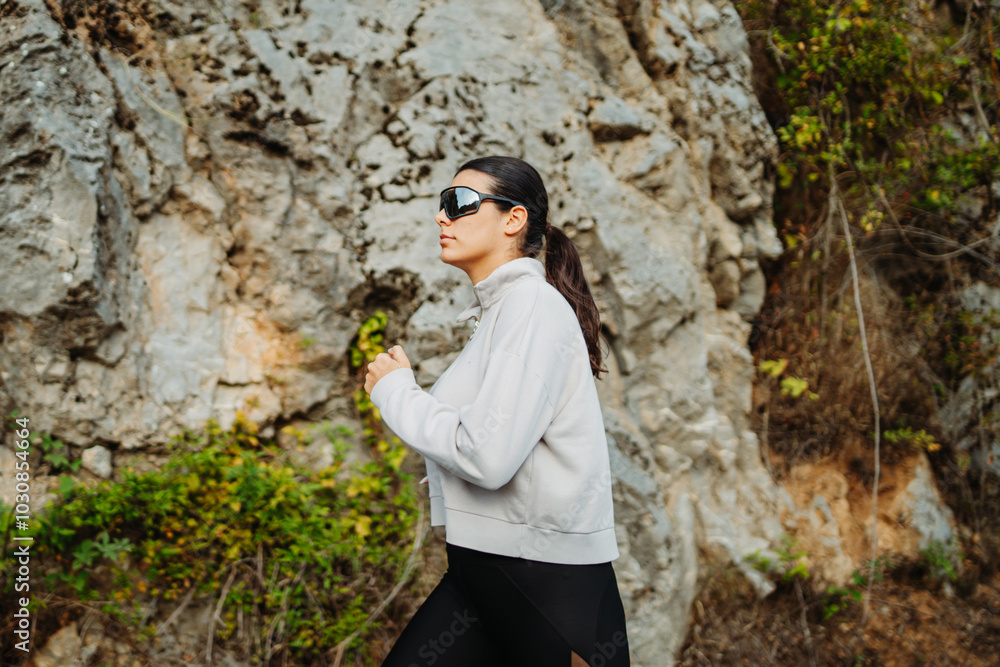 Young caucasian woman running or jogging on the country road Young caucasian woman running or jogging on the country road