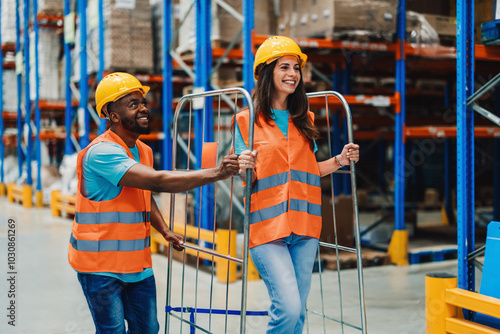 Warehouse workers transporting goods using metal cart photo