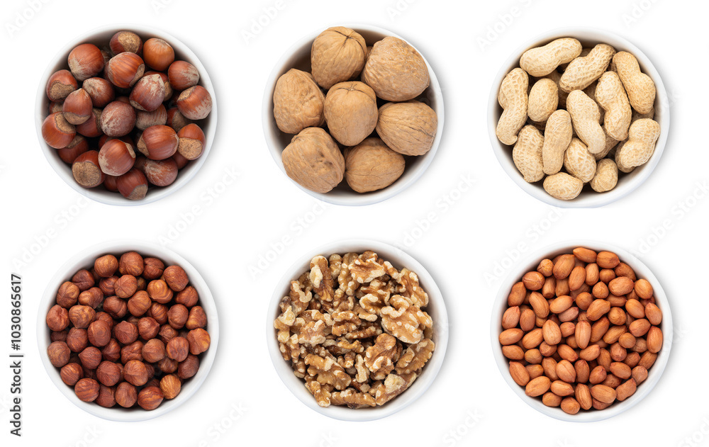 Bowl plates with hazelnut and walnut and peanut nuts isolated on white background.Top view. Bowl plates with hazelnut and walnut and peanut nuts isolated on white background.Top view.