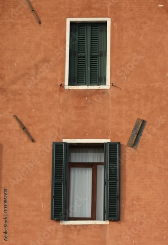 Decorative wooden window on an old building in Italy