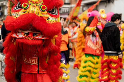 Red lion dancing among de crowd of people as sign on good luck on a Chinese new year festival