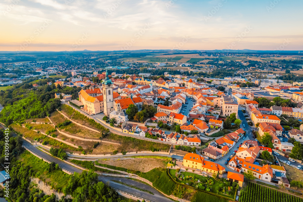 Fototapeta premium Melnik Castle on the hill above Labe and Vltava River in sunny day. Church with city space and square. Czech Republic.