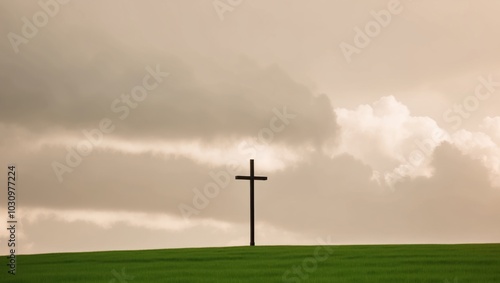 Cross Standing Alone in a Grassy Field Under Clouds. photo