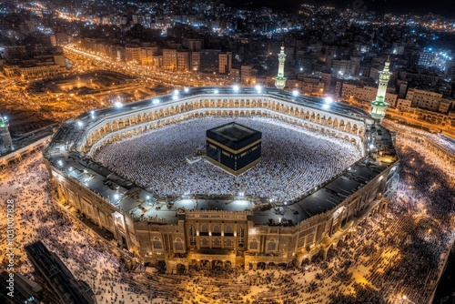 Aerial view of the illuminated Kaaba surrounded by worshippers at night