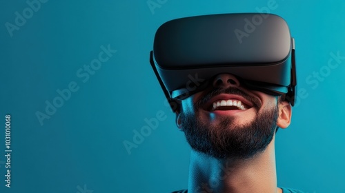 A young man smiles as he engages with a virtual reality headset, immersed in a digital environment that provides an entertaining experience indoors