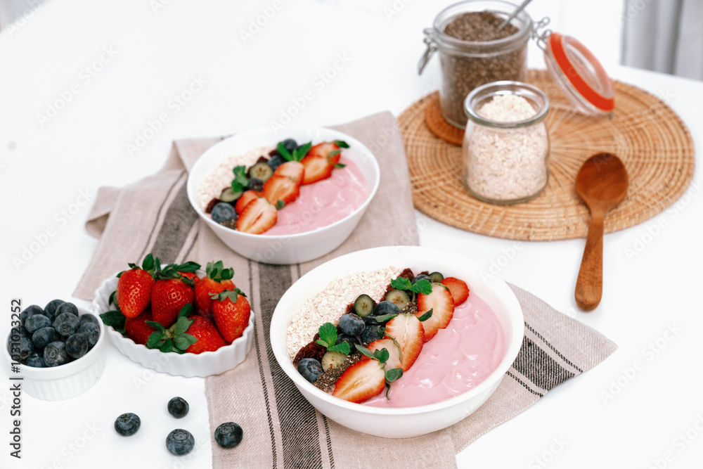 Presented by fruits putting yogurt toppings with strawberry, berry, oats, raisins and chia seed decorated by peppermint in white blow. Pink background. Set of healthy dairy product choice. Pecuniary. Presented by fruits putting yogurt toppings with strawberry, berry, oats, raisins and chia seed decorated by peppermint in white blow. Pink background. Set of healthy dairy product choice. Pecuniary.