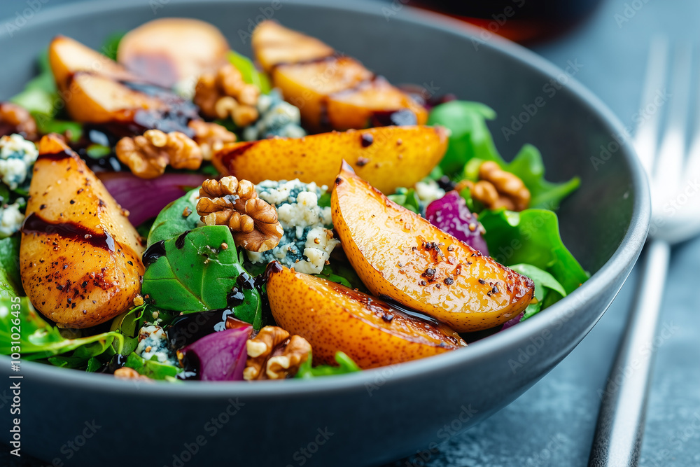 A close up of a fall-inspired salad featuring roasted pears, walnuts, and crumbled blue cheese, drizzled with balsamic glaze in a bowl A close up of a fall-inspired salad featuring roasted pears, walnuts, and crumbled blue cheese, drizzled with balsamic glaze in a bowl