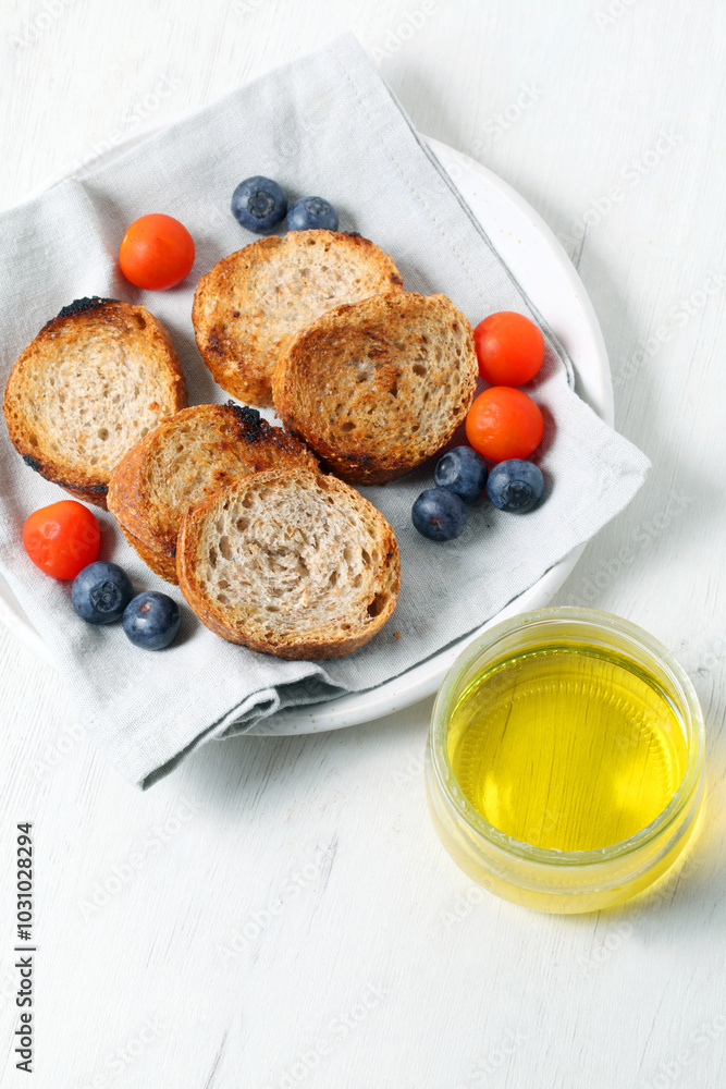 Slices of toasted whole wheat bread and olive oil Slices of toasted whole wheat bread and olive oil