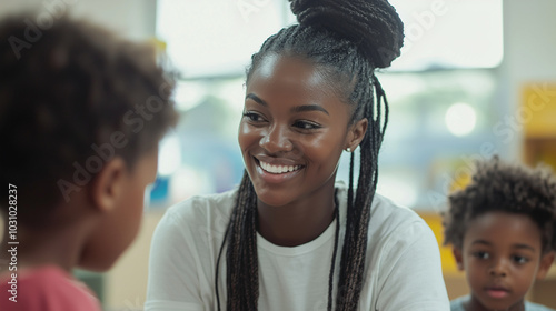 Wallpaper Mural Portrait of a social worker at a youth shelter, interacting with children in a colorful and supportive environmentphoto Torontodigital.ca