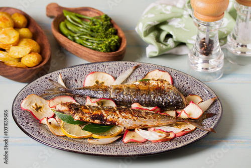 Grilled mackerel with apples, onoions and bay leaves photo