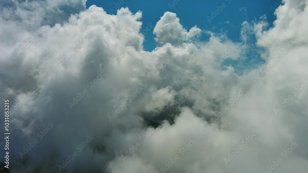 Obraz premium Flying through white fluffy clouds