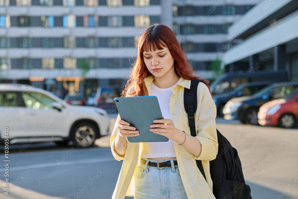 Young female college student using digital tablet outdoor Young female college student using digital tablet outdoor