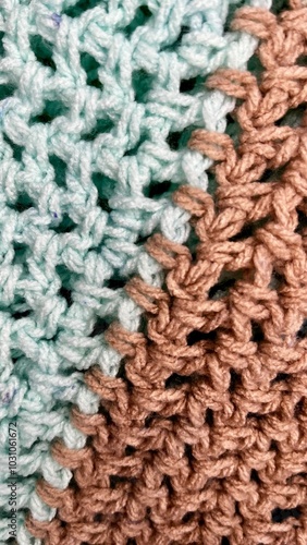 brown and blue wool thread crochet texture . gray background close . top view . copy space