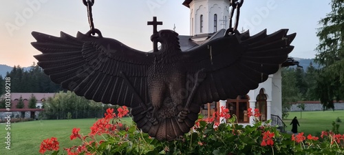 Bronze cross bearing eagle statue at an orthodox monastery.