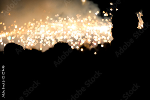 People silhouette against fireworks of the Santa Tecla Festival Parade, Tarragona, Spain 22nd September 2024 photo