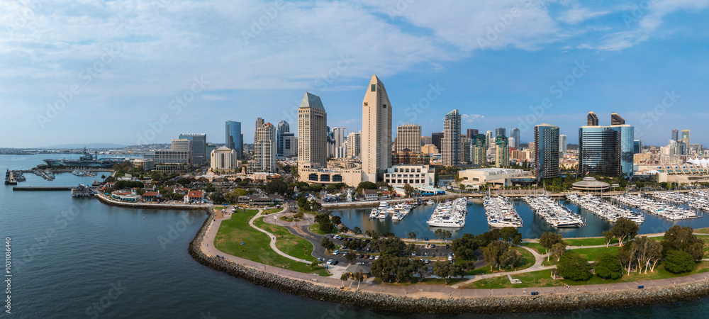 Aerial view of San Diego's skyline featuring high rise buildings, the Marriott Marquis, Manchester Grand Hyatt, a marina, and San Diego Bay.