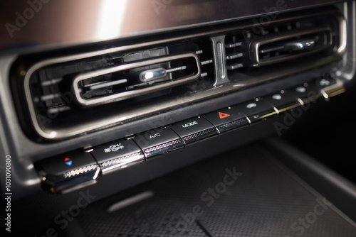 Closeup of car dashboard air vents near gear shift