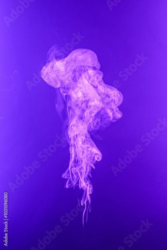 Twisted plume of smoke. The movement of smoke on a colored background. Abstract smoke lines