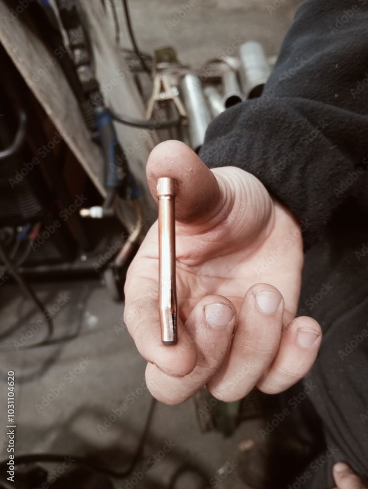 close up of a hand holding a wrench