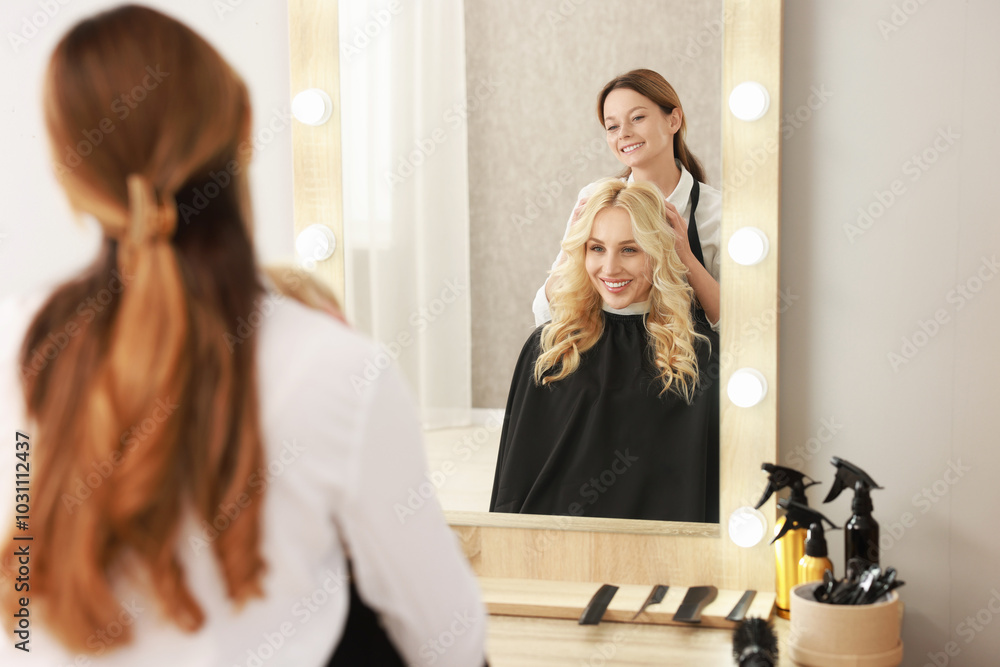 Hair cutting. Professional hairdresser working with client in salon, selective focus Hair cutting. Professional hairdresser working with client in salon, selective focus