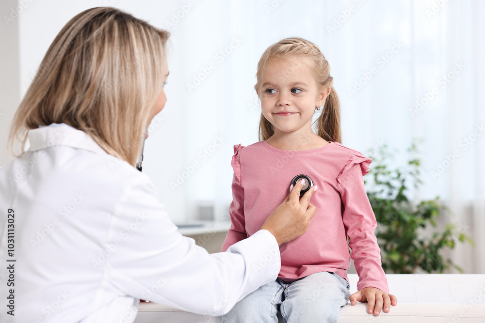 Doctor examining little girl with stethoscope in hospital Doctor examining little girl with stethoscope in hospital