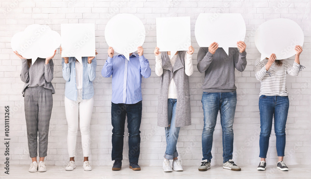 Naklejka premium Social opinion concept. Group of people hiding faces behind blank speech bubbles, free space