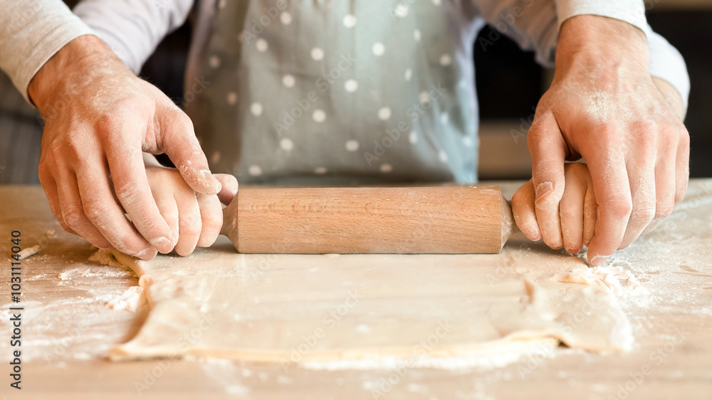 Homemade Food Concept. Unrecognizable Man And His Little Daughter Rolling Pastry Dough Together, Cooking Bakery In Kitchen, Cropped Image, Closeup Homemade Food Concept. Unrecognizable Man And His Little Daughter Rolling Pastry Dough Together, Cooking Bakery In Kitchen, Cropped Image, Closeup
