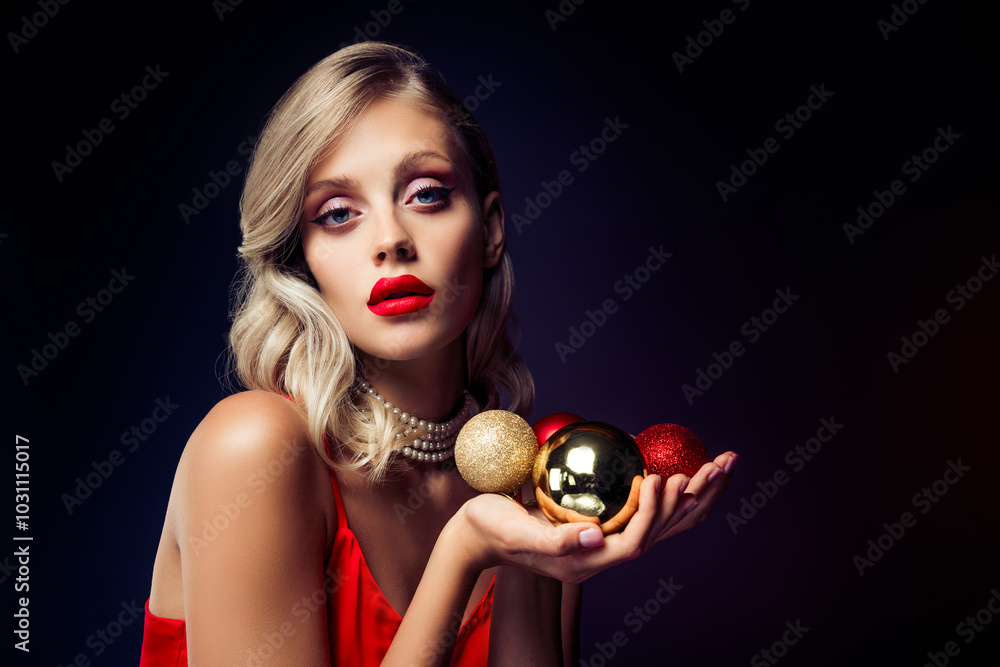 Stunning charming model hold exclusive shiny xmas tree balls isolated on dark color background Stunning charming model hold exclusive shiny xmas tree balls isolated on dark color background