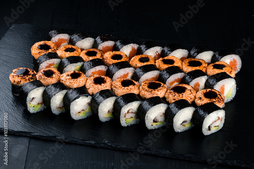 Obraz na płótnie Set of maki sushi rolls with tuna, salmon, sea bass, cream cheese, avocado and teriyaki sauce. w salonie