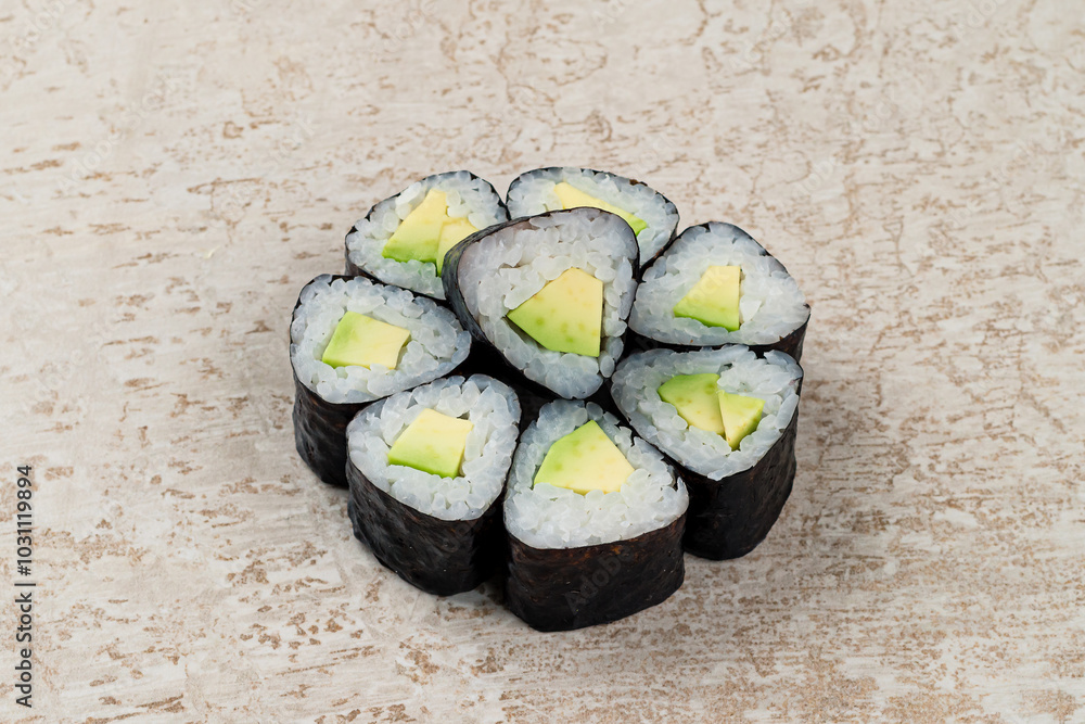 Traditional Japanese cuisine set of maki sushi rolls with avocado, rice and nori.