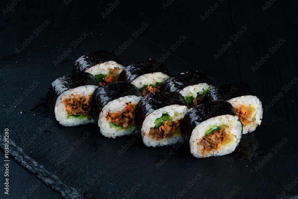 Japanese lunch set of sushi rolls with tuna, sea bass, cucumber, rice and nori. Japanese lunch set of sushi rolls with tuna, sea bass, cucumber, rice and nori.