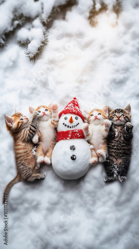 small, cute kittens playing happily in the snow with a snowman during the winter season in outdoor activities in nature