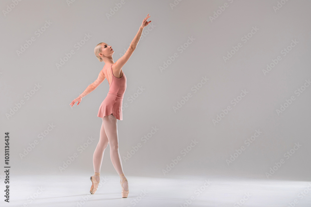 Ballerina in pink leotard dancing on white background. Ballerina in pink leotard dancing on white background.