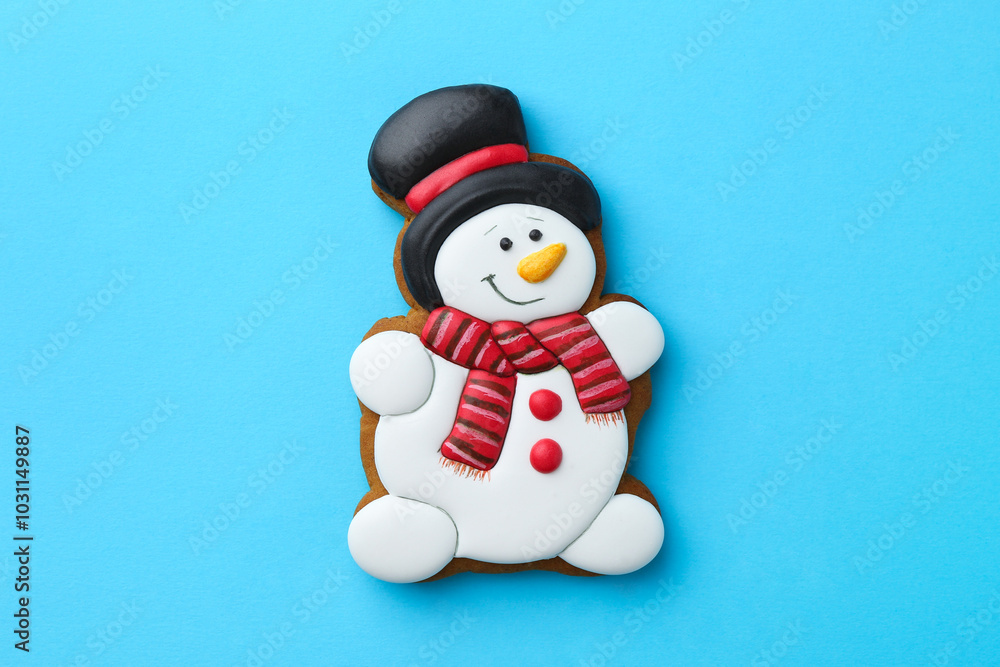 Tasty Christmas cookie in shape of snowman on light blue background, top view Tasty Christmas cookie in shape of snowman on light blue background, top view