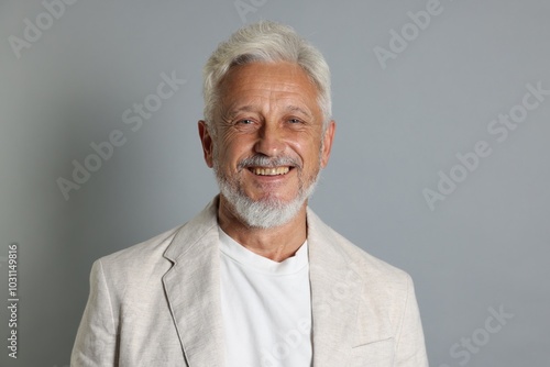 Portrait of senior man on grey background