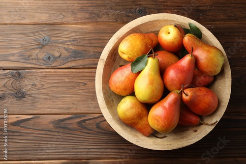 Ripe juicy pears on wooden table, top view. Space for text