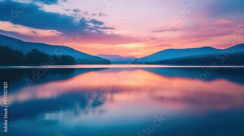 A serene landscape with a calm lake reflecting the vibrant hues of a sunset sky. The mountains in the distance are silhouetted against the fiery sky, creating a picturesque scene.