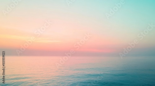 Obraz na płótnie A soft, pastel sunrise over a calm ocean with a blurred effect. w salonie