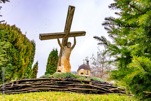 Sculpture Jesus Christ carrying his cross, old monastery Hincu in Moldova. Background with selective focus photo