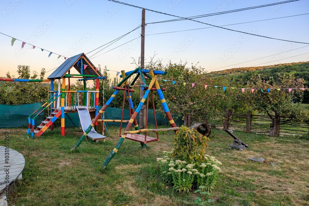 A colorful playground with a swing set and a slide A colorful playground with a swing set and a slide