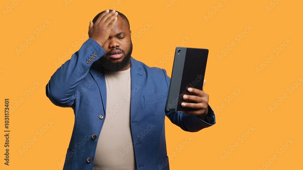 Discontented man disappointed by friends words during videoconference meeting, isolated over studio background. Upset person hearing bad news from mates during internet videocall, camera A Discontented man disappointed by friends words during videoconference meeting, isolated over studio background. Upset person hearing bad news from mates during internet videocall, camera A