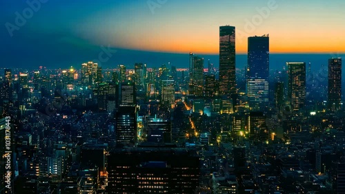 Wallpaper Mural City skyline at sunset with vibrant lights and towering buildings. Torontodigital.ca