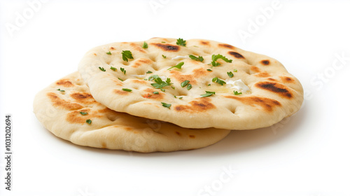 Freshly baked naan bread topped with herbs, showcasing golden brown crust and soft texture, perfect for pairing with various dishes.