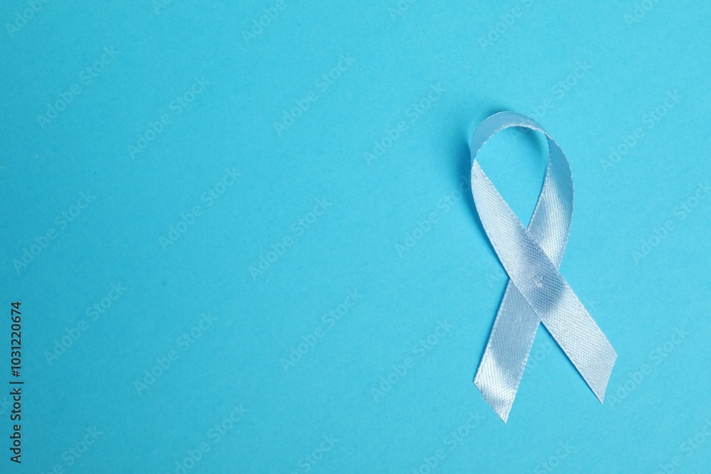 Light blue ribbon on color background, top view with space for text. Prostate cancer awareness Light blue ribbon on color background, top view with space for text. Prostate cancer awareness